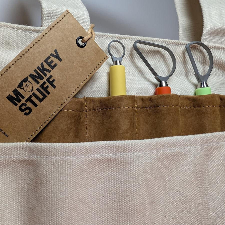 Monkey Stuff tag on a canvas tool bag with Tortuga tools